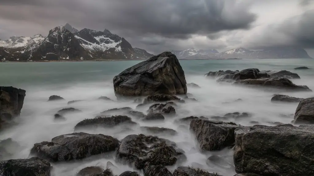 Rounded shore stones and sea in a long exposure, Lofoten
